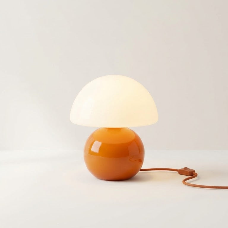 Opal Glass Mushroom Table Lamp lit, showing the opal glass dome shade on a glossy orange glass sphere base
