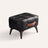 Tufted faux leather ottoman in black, white studio packshot