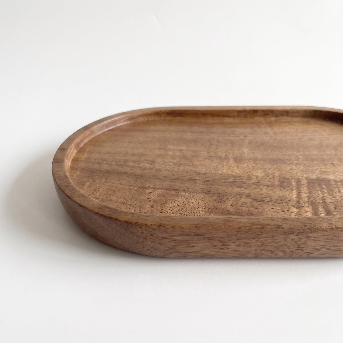 Oval wood tray, detail of grain and curved interior