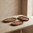 Three-piece oval wood tray set styled on a table