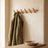 Oak wall peg rack styled in an entryway scene