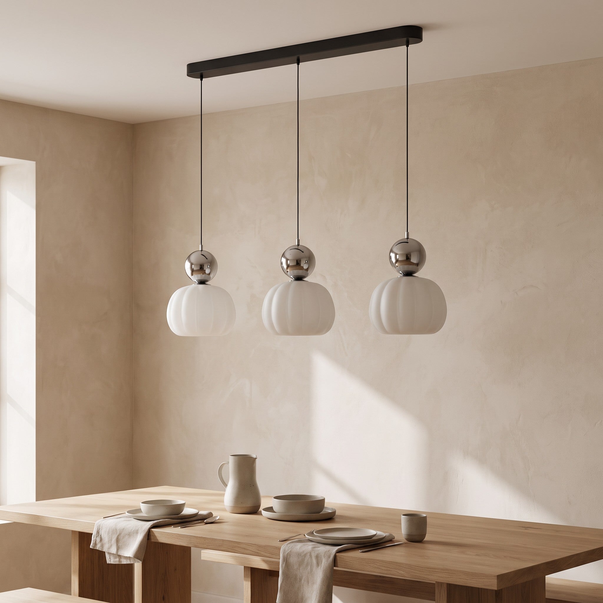 Three-head chrome pumpkin pendant light in a dining room scene