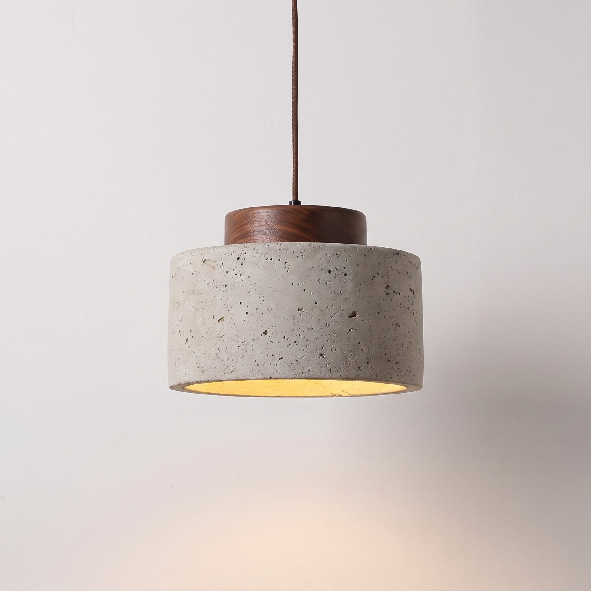 Stone-look pendant, wide shade with a dark wood cap, lit