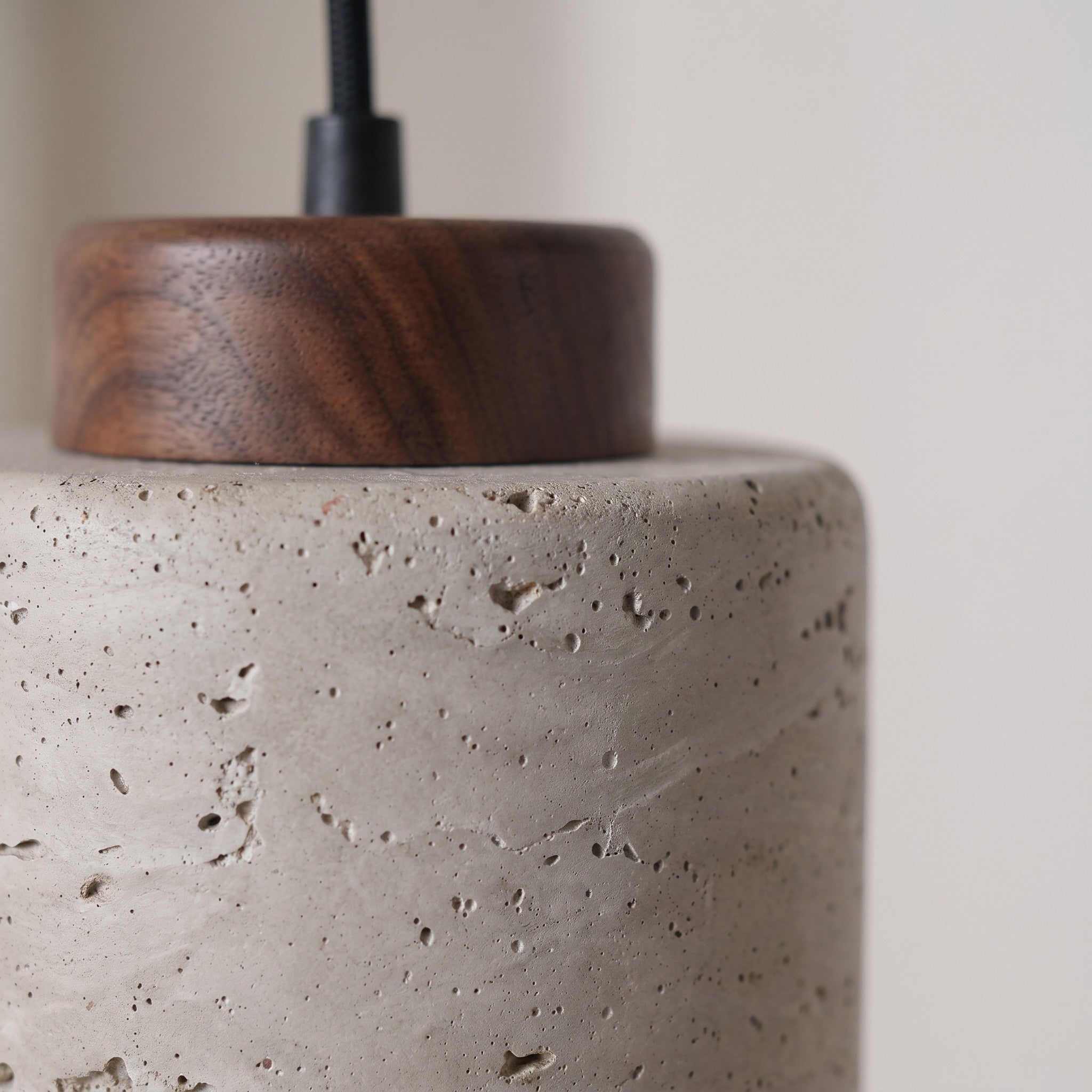 Close detail of the speckled matte shade and turned wood cap