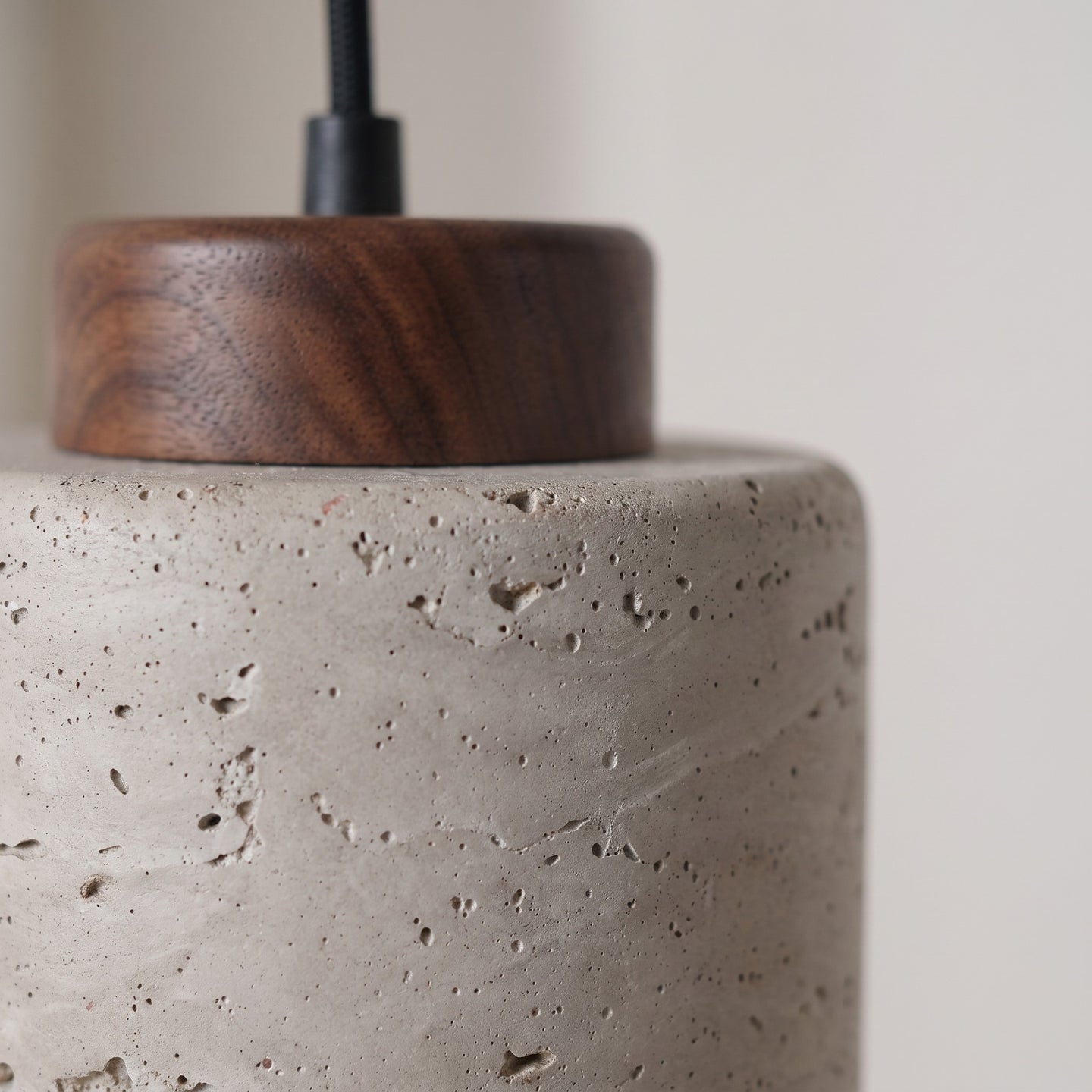 Close detail of the speckled matte shade and turned wood cap