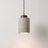 Stone-look pendant, tall shade with a dark wood cap, lit