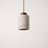 Stone-look cylinder pendant with a dark wood cap, studio packshot
