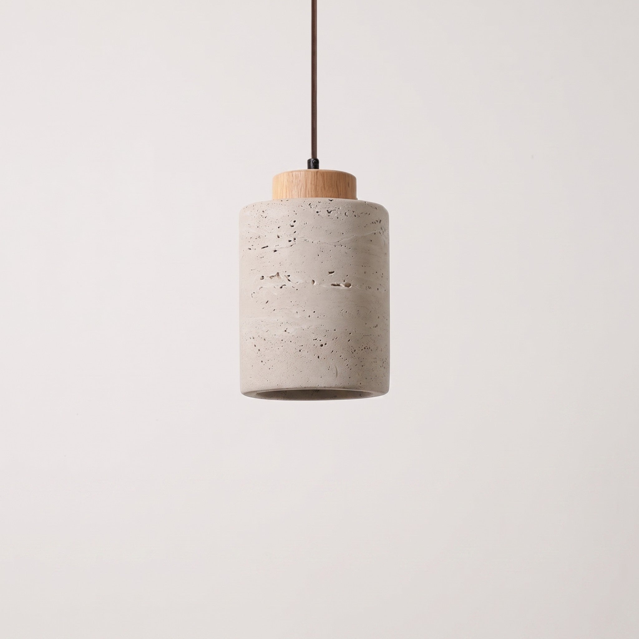 Stone-look cylinder pendant with a natural wood cap, studio packshot