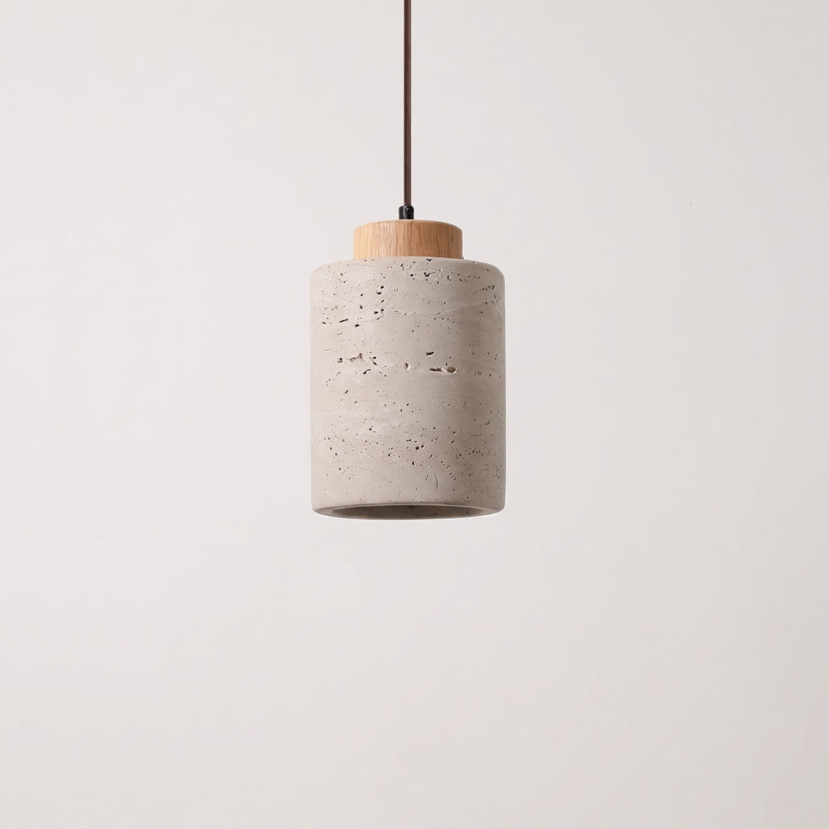 Stone-look cylinder pendant with a natural wood cap, studio packshot