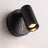 Close detail of the reading light head and its round magnetic wall plate