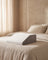 Memory foam leg wedge pillow at the foot of a bed