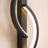 Close detail of the glowing ribbon against the black sconce frame