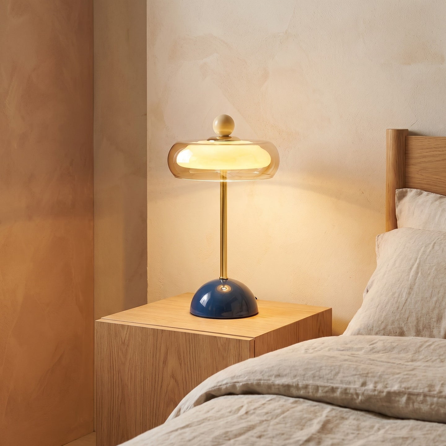 Blue glass ring table lamp styled on a nightstand scene