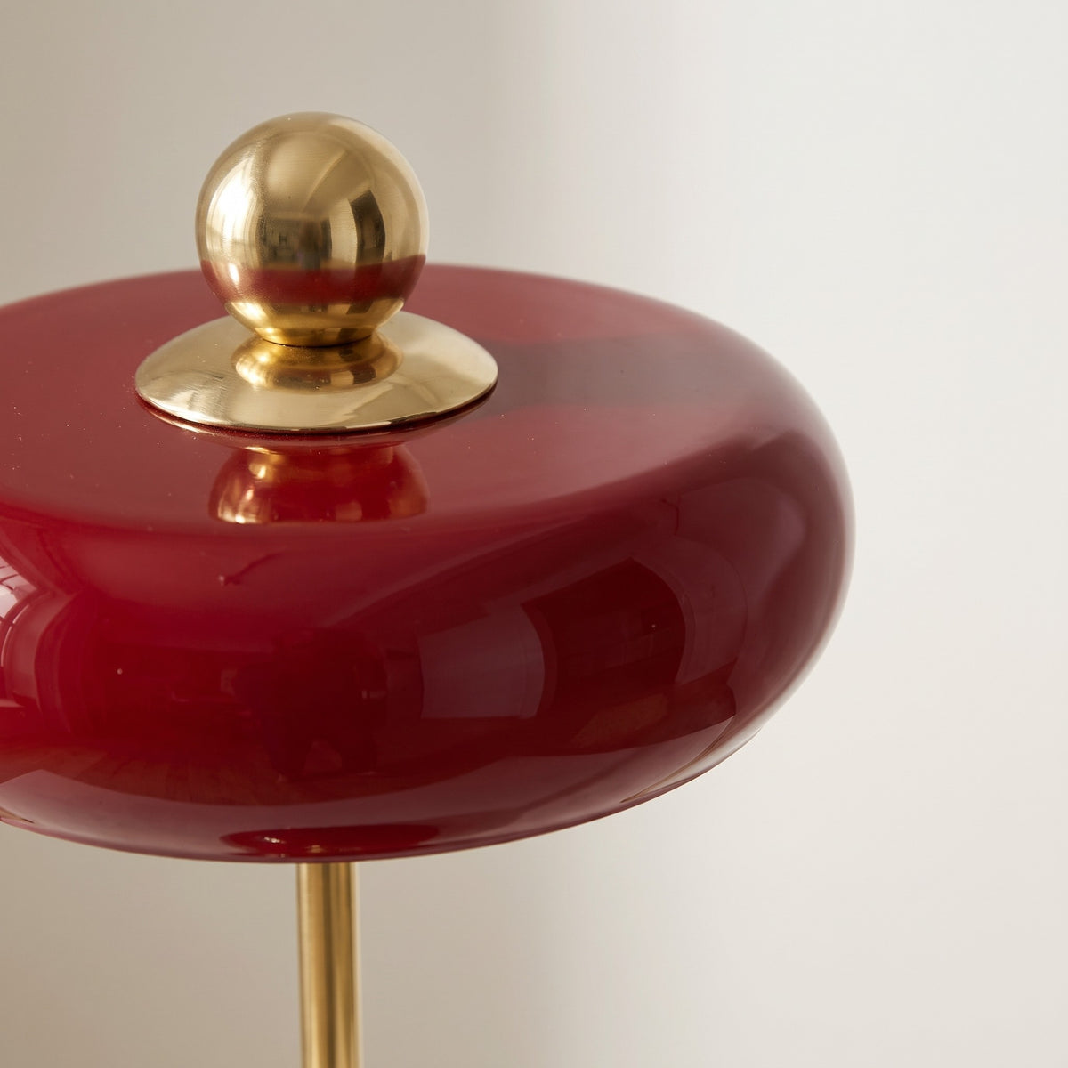 Close-up of lacquered glass ring table lamp shade in red