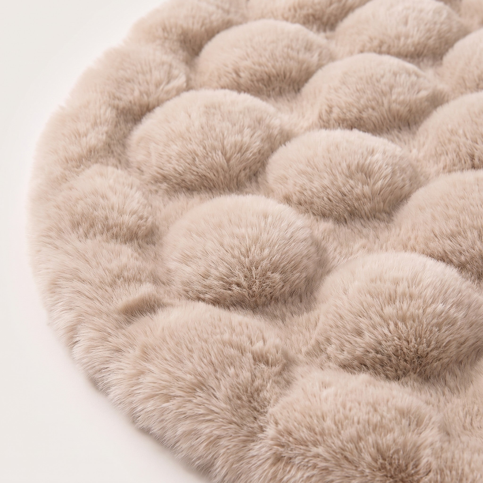 Close-up of round bubble-texture fleece rug surface in cream