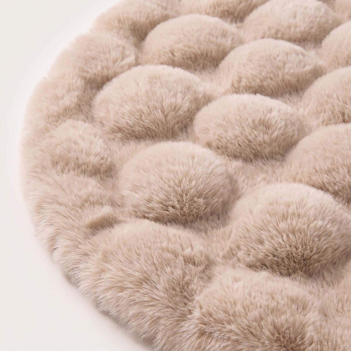 Close-up of round bubble-texture fleece rug surface in cream