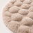 Close-up of round bubble-texture fleece rug surface in cream