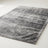 Plush faux-fur area rug in mottled gray on a plain off-white background