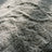 Close-up of the dense velvety faux-fur pile of the area rug in mottled gray