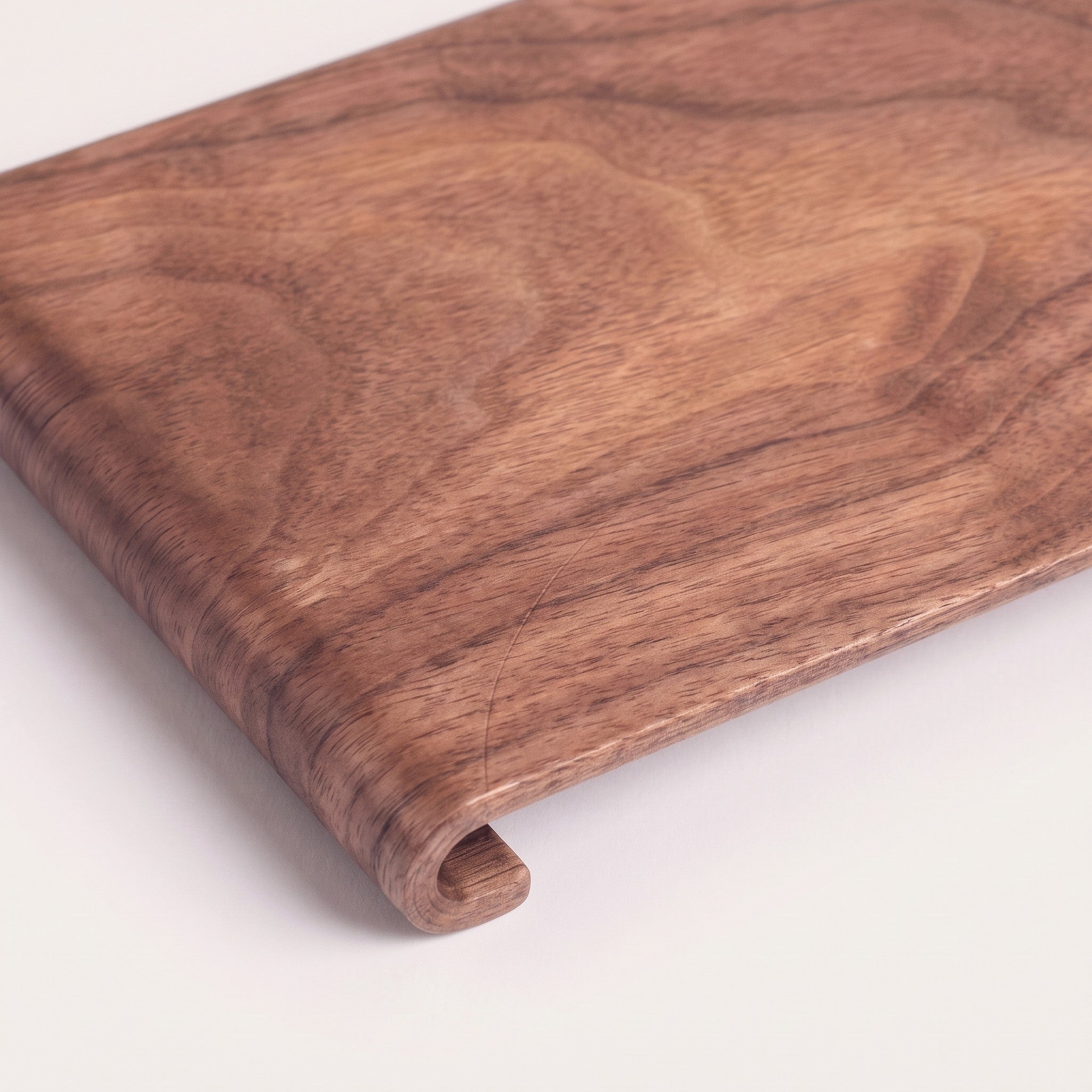 Rectangular wood serving tray, detail of grain and rolled edge