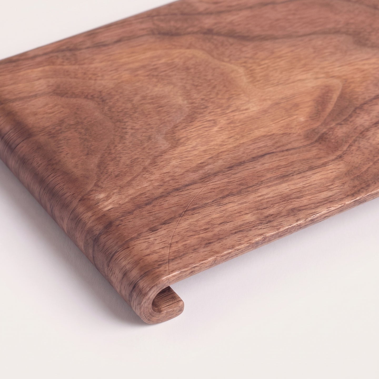 Rectangular wood serving tray, detail of grain and rolled edge