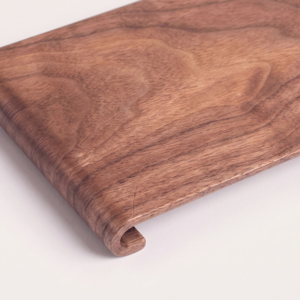 Rectangular wood serving tray, detail of grain and rolled edge