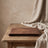 Rectangular wood serving tray styled on a table