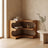 Bamboo corner shelf in a room corner beside a travertine side table