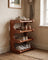 4-tier corner shoe rack loaded with shoes in a narrow entryway, plaster wall and wood flooring