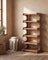 Corner shoe rack styled in a warm entryway scene with plaster wall and oatmeal linen throw