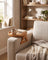 Sofa arm tray clipped onto a sofa arm in a cozy reading nook with a folded throw blanket