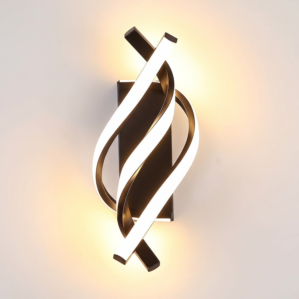 Spiral LED wall sconce in black, lit, glowing ribbon on a black frame
