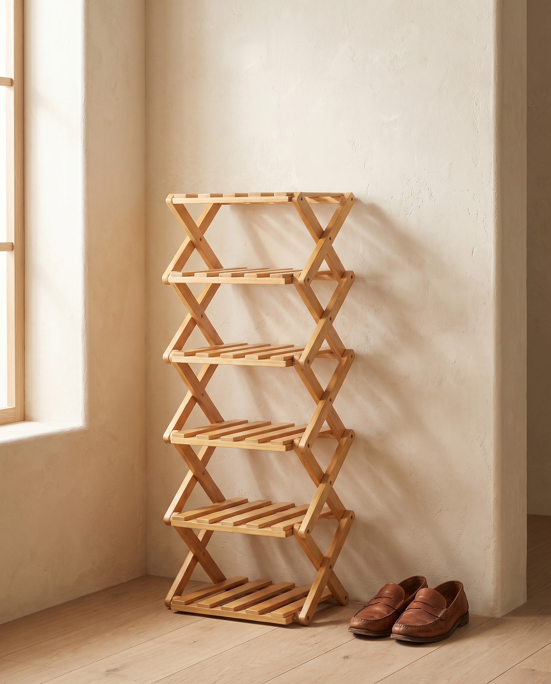 Bamboo folding shoe rack styled in an entryway scene