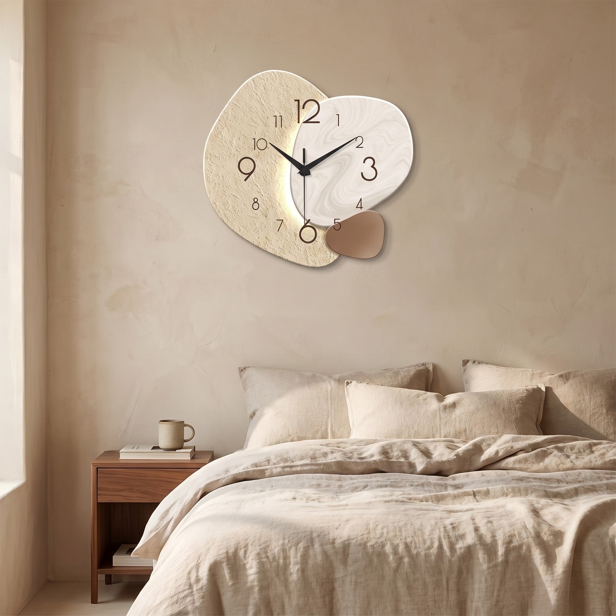 Three Pebble Silent Wall Clock hanging on a limewash plaster wall above a bed with oatmeal linen bedding.