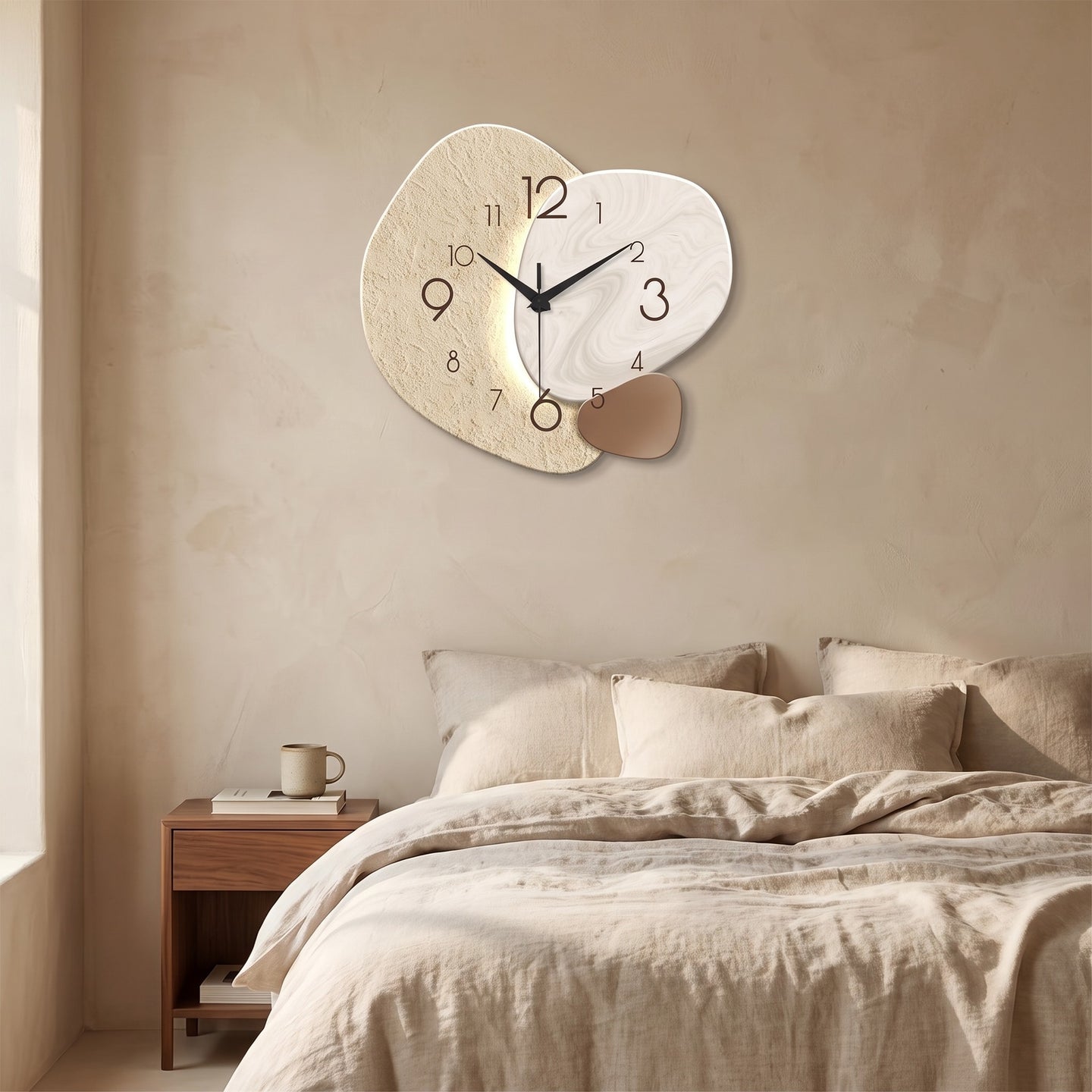 Three Pebble Silent Wall Clock hanging on a limewash plaster wall above a bed with oatmeal linen bedding.