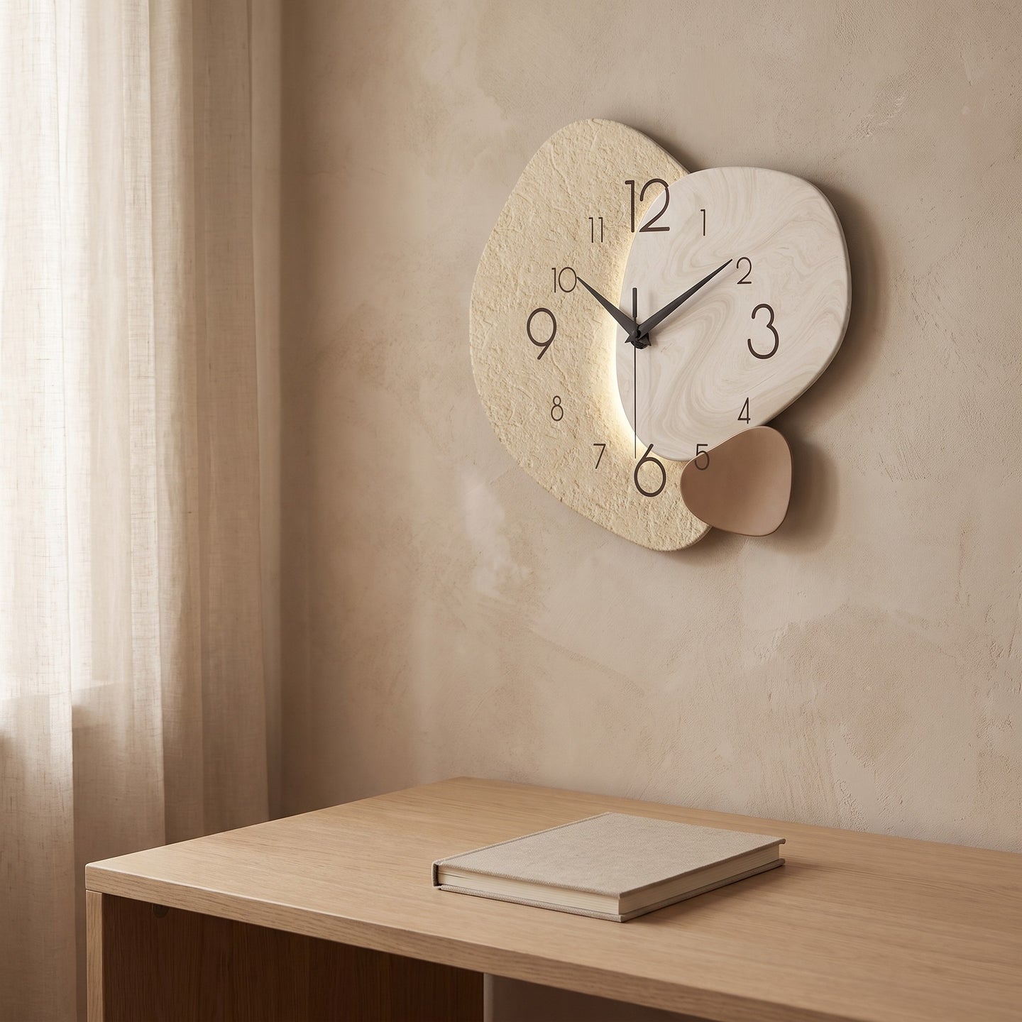 Three Pebble Silent Wall Clock hanging on a plaster wall above a white oak desk in daylight.
