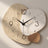 Close-up of the Three Pebble Silent Wall Clock showing the printed seam where the sand-textured pattern meets the marbled pattern on the single-piece face.