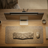 Wooden desk with computer setup including keyboard, mouse, and monitor on a neutral background