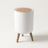Round wood-grain trash can with a press-open lid on a plain off-white background
