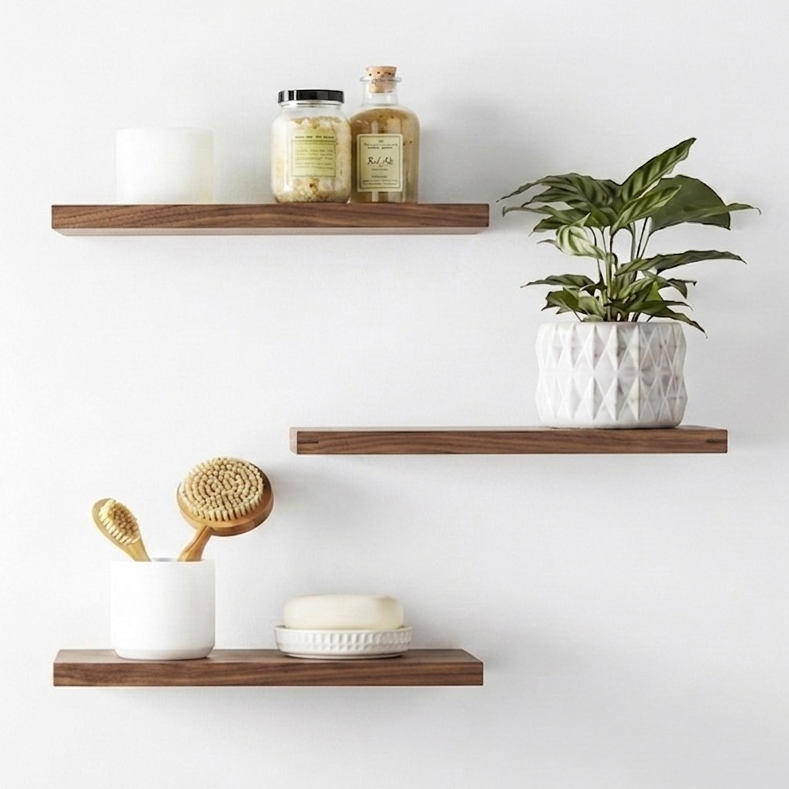 Three wooden shelves with decorative items on a white wall