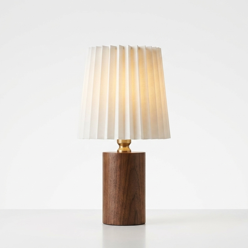 Table lamp with a wooden base and pleated fabric shade on a white background