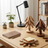 Wooden desk accessories including a lamp, trees, and a notebook on a wooden table.