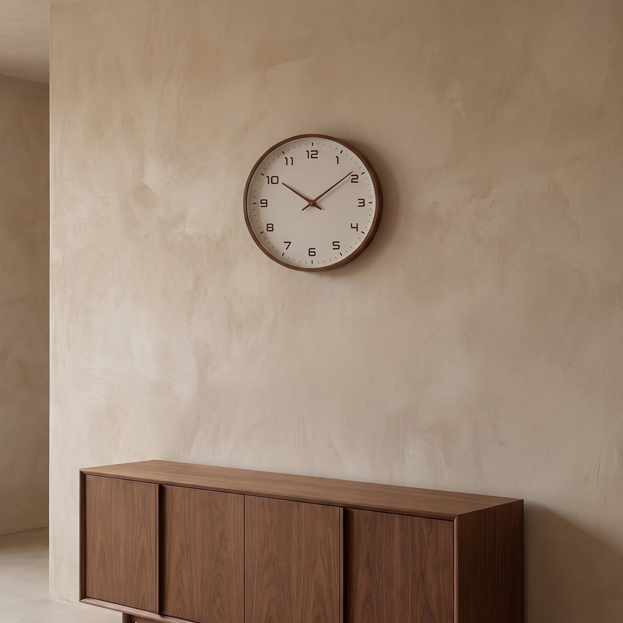 Brown Wood Frame Silent Wall Clock hanging above a walnut sideboard, seen from across the room to show its 11.8 inch size.