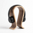 Wooden headphone stand holding black headphones on a white background